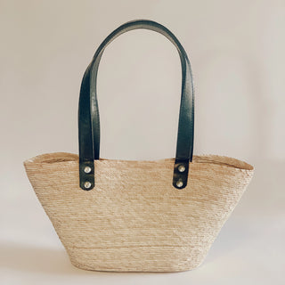 Jute Straw tote with leather handles in studio background