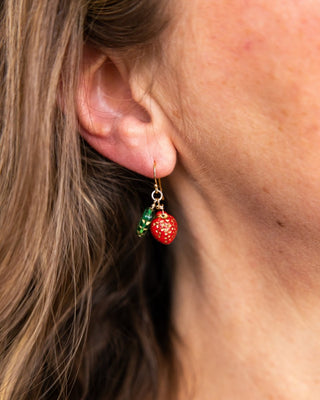 Strawberry earrings with green leaf in 14k gold fill on womans ear