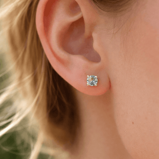 Blue_topaz_5mm_round_gemstone_stud_earrings_on_silver