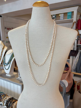 Mannequin bust with a long white pearl strand on