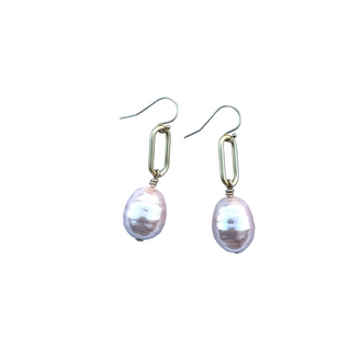 Pair of pearl earrings on a light blue background