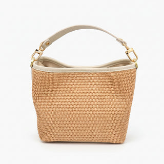 Woven handbag with beige handle and tag on a white background